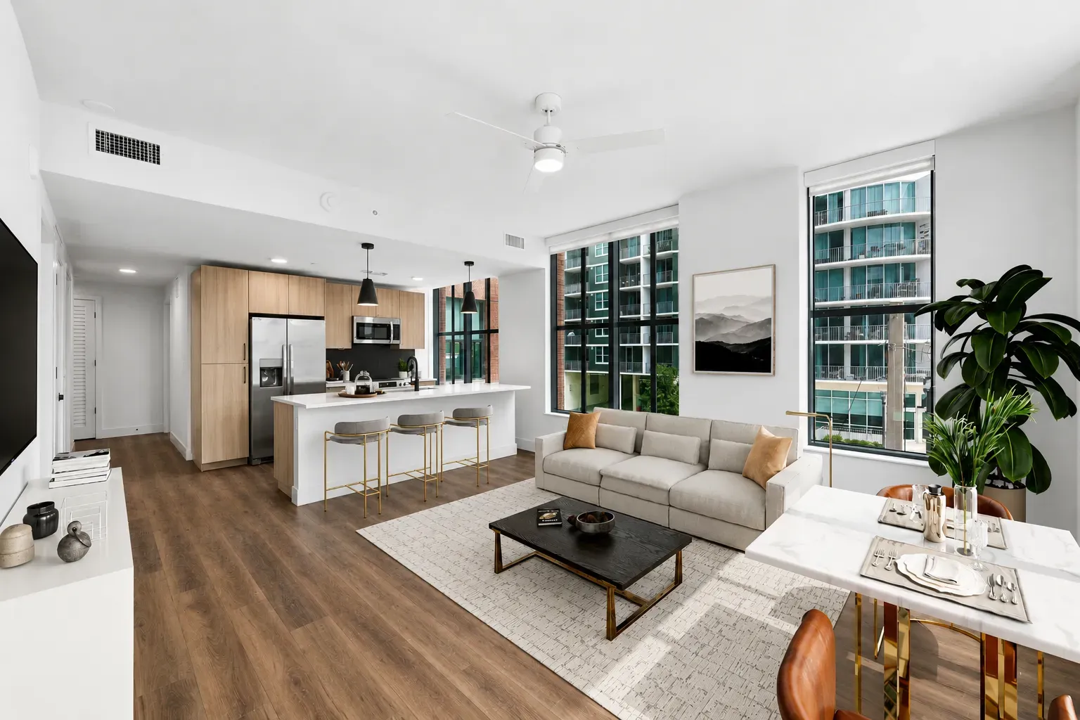 Spacious apartment living area with hardwood floors and bright windows.