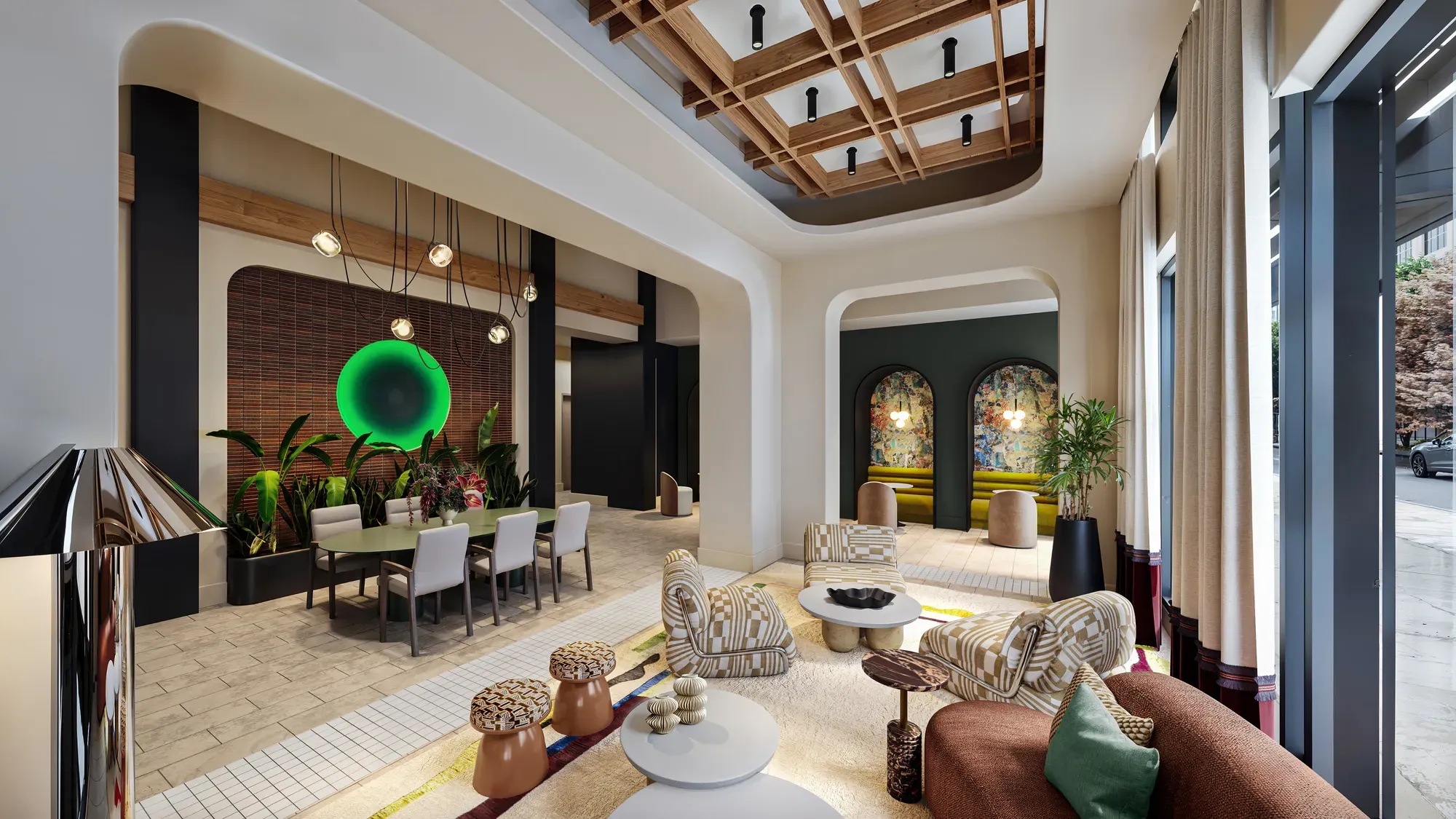Spacious modern building lobby featuring plush seating areas, high coffered ceilings, and a dining setup.